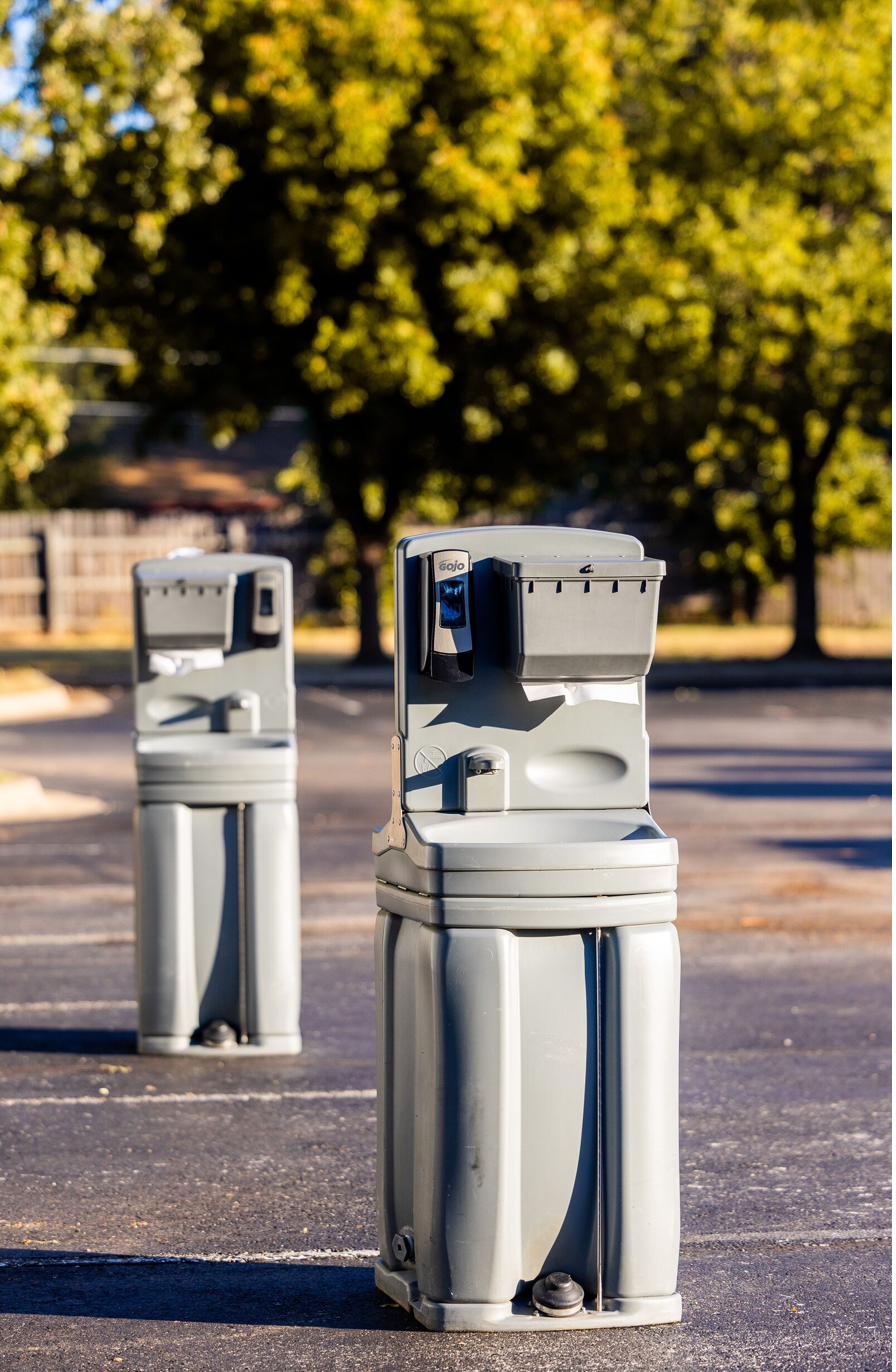 Two freestanding hand washing stations outdoors